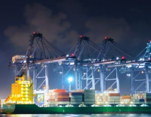 Cranes moving cargo in a Bangkok, Thailand shipping port